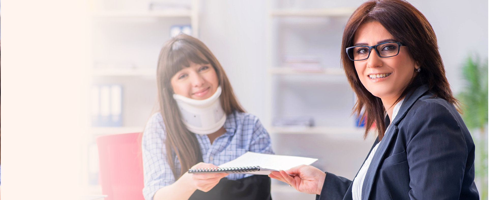 medical personnel and her patient holding a paper